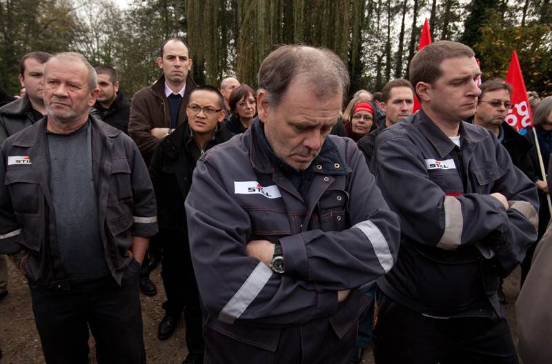 Workers in front of factory pay hommage to José Montero; Nov. 18, 2011.