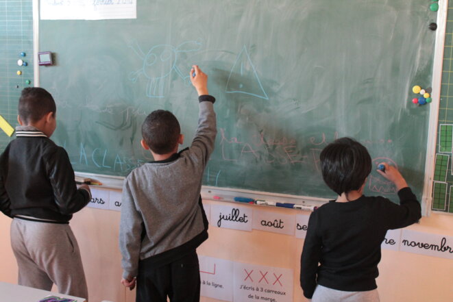 Mohamed (à droite) et deux autres élèves dans une classe installée dans un préfabriqué à l'école Saint-Louis Consolat © Margaïd Quioc
