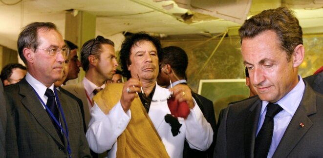 Left to right: Nicolas Sarkozy’s chief of staff Claude Guéant, Muammar Gaddafi and the newly elected president Sarkozy in Tripoli in July 2007. © Reuters