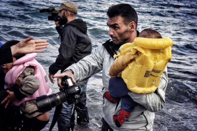 aris-messinis-transporte-un-enfant-sur-le-rivage-a-lesbos