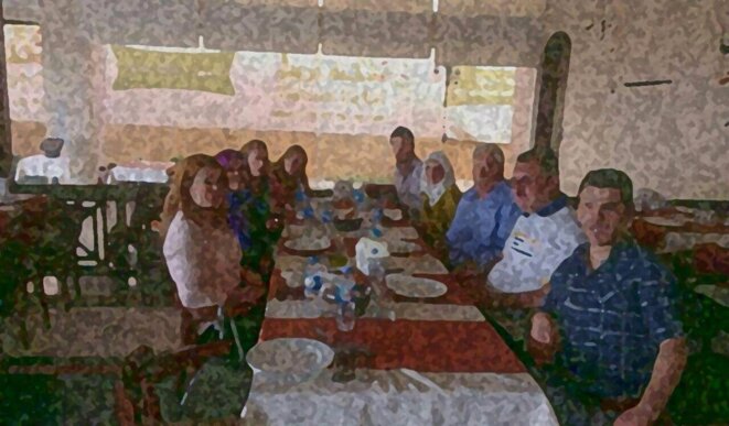 The family at the Grand Station restaurant in Aleppo before the war: the photo has been altered to protect their identity and to prevent reprisals against members of the family still living in Syria.
