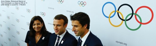 Paris mayor Anne Hidalgo, President Emmanuel Macron and former French Olympics gold medallist Tony Estanguet at an IOC meeting in Lausanne, July 11th.  © Reuters