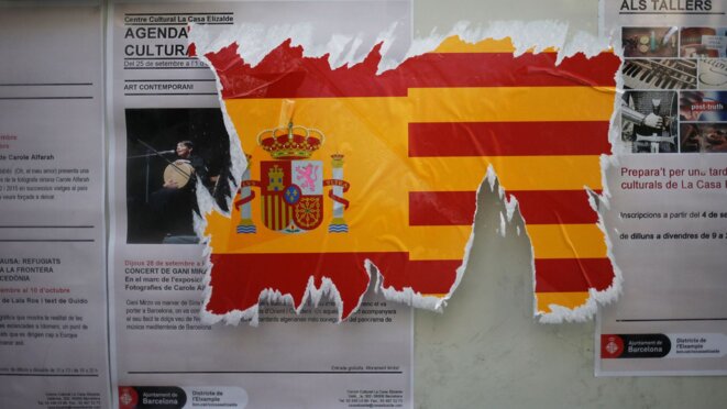 a-damaged-sticker-of-the-spanish-flag-is-seen-on-a-wall-ahead-of-the-banned-october-1-independence-referendum-in-barcelona-5953268