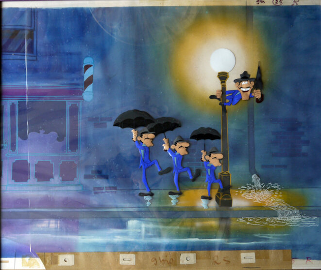 Cellulo. Dans La Ballade des Daltons (le rêve de Joe), en 1978, Goscinny et Morris transposent une scène de Chantons sous la pluie de Stanley Donen, 1952. Crédit : La Ballade des Daltons, Co-production DARGAUD Productions/RENÉ GOSCINNY productions / IDEFIX Studio ©Productions Dargaud Films – Paris / René Goscinny / Morris. Tous droits réservés. Cellulo. Dans La Ballade des Daltons (le rêve de Joe), en 1978, Goscinny et Morris transposent une scène de Chantons sous la pluie de Stanley Donen, 1952. Crédit : La Ballade des Daltons, Co-production DARGAUD Productions/RENÉ GOSCINNY productions / IDEFIX Studio ©Productions Dargaud Films – Paris / René Goscinny / Morris. Tous droits réservés.