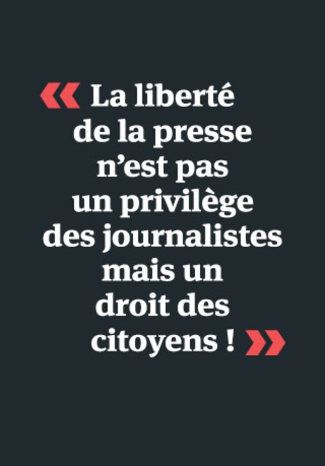 The poster reads: 'Freedom of the press isn't a privilege for journalists but a right for citizens!' The poster reads: 'Freedom of the press isn't a privilege for journalists but a right for citizens!'