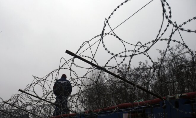 A Hungarian police officer stands guard at the border with Serbia. © Darko Vojinovic - AP A Hungarian police officer stands guard at the border with Serbia. © Darko Vojinovic - AP