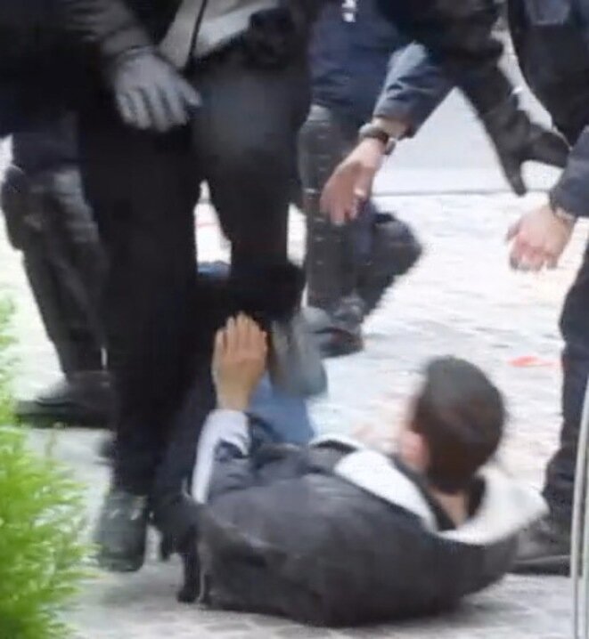 A still from the video (see further below) obtained by Mediapart which shows Alexandre Benalla jumping and stamping on the young man who he later had arrested. © DR A still from the video (see further below) obtained by Mediapart which shows Alexandre Benalla jumping and stamping on the young man who he later had arrested. © DR