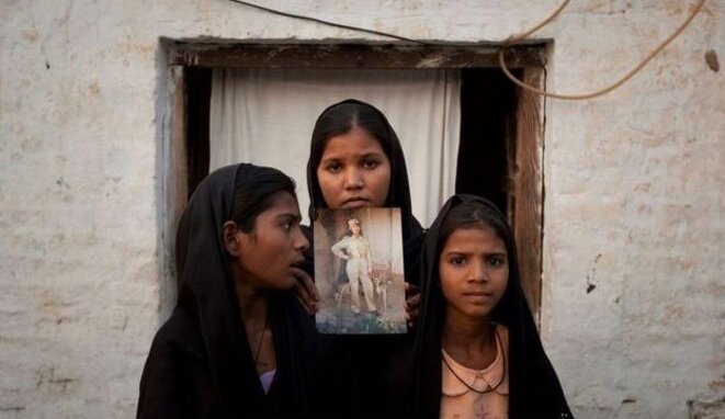Les filles d'Asia Bibi montrant la photo de leur mère, le 13 novembre 2010. © Reuters Les filles d'Asia Bibi montrant la photo de leur mère, le 13 novembre 2010. © Reuters
