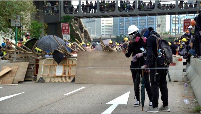 Les manifestants ayant monté des barricades regardent leurs smartphones en attendant les sommations de la police. Hong Kong le 24/08/2019 © Pierre Thomas Les manifestants ayant monté des barricades regardent leurs smartphones en attendant les sommations de la police. Hong Kong le 24/08/2019 © Pierre Thomas