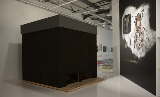 Olivier Raud, La chambre d’abeilles, 2020, sculpture en pin douglas, liège, tissus occultant, cadres de ruche, ruches, 300 x 300 cm, et Abraham Poincheval, Sans titre (ruche), dessin mural, 5m x 5m, 2020 (Photo Alain Alquier) Olivier Raud, La chambre d’abeilles, 2020, sculpture en pin douglas, liège, tissus occultant, cadres de ruche, ruches, 300 x 300 cm, et Abraham Poincheval, Sans titre (ruche), dessin mural, 5m x 5m, 2020 (Photo Alain Alquier)