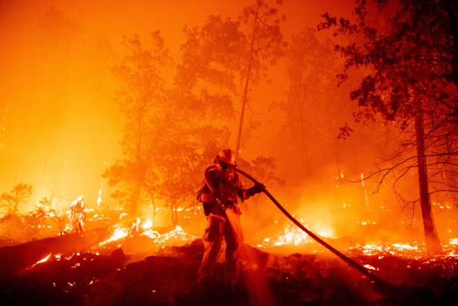 Un pompier étouffe les flammes alors qu'elles se dirigent vers les maisons lors de l'incendie de Creek dans la région de Cascadel Woods, dans le comté de Madera, en Californie, le 7 septembre 2020. © Josh Edelson / AFP
