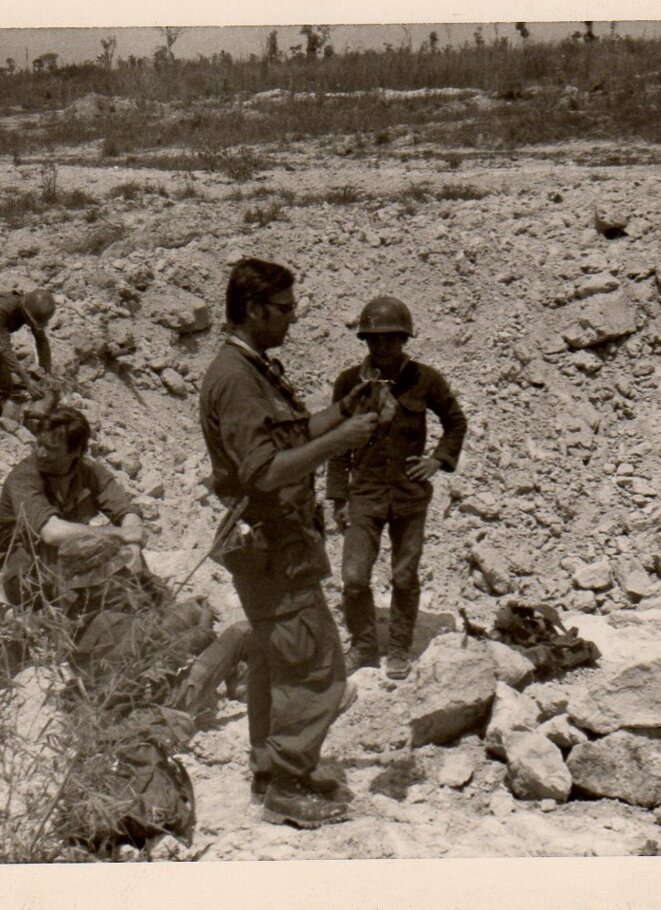 Lucien (in the foreground) in Vietnam in 1972, examining a crater left by a bomb dropped from a US B52 plane. © DR Lucien (in the foreground) in Vietnam in 1972, examining a crater left by a bomb dropped from a US B52 plane. © DR