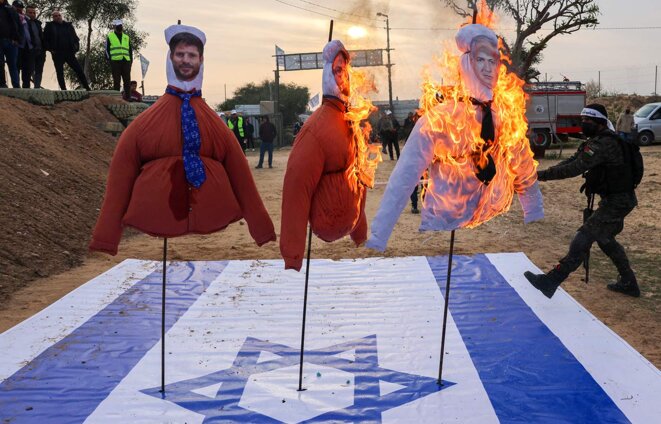 Des militants palestiniens de la brigade Ansar brûlent le drapeau israélien et des effigies de Benjamin Netanyahou, Itamar Ben Gvir et Bezalel Smotrich, à Khan Yunis, le 1er janvier 2023. © Photo Saïd Khatib / AFP